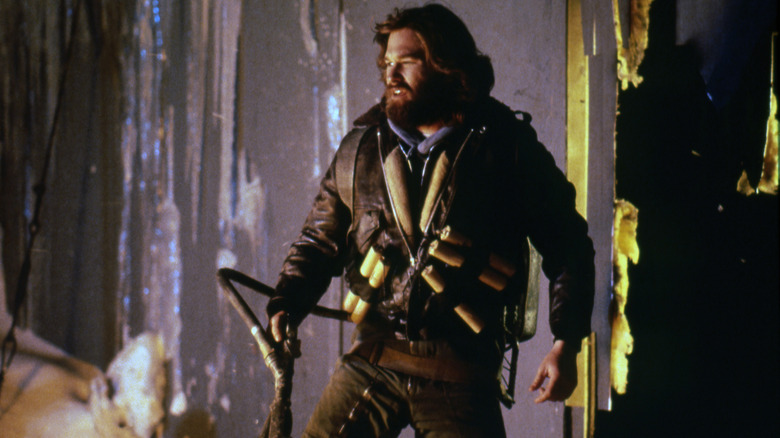 R. J. MacReady with a flamethrower fighting an alien force in The Thing (1982)