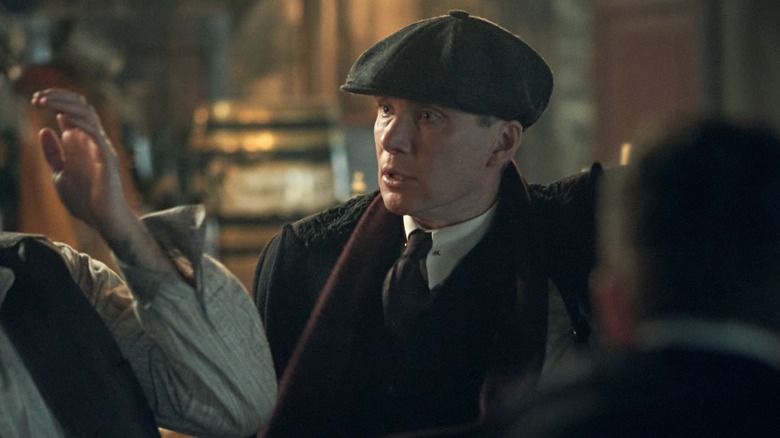Tommy glares at someone in "Peaky Blinders"