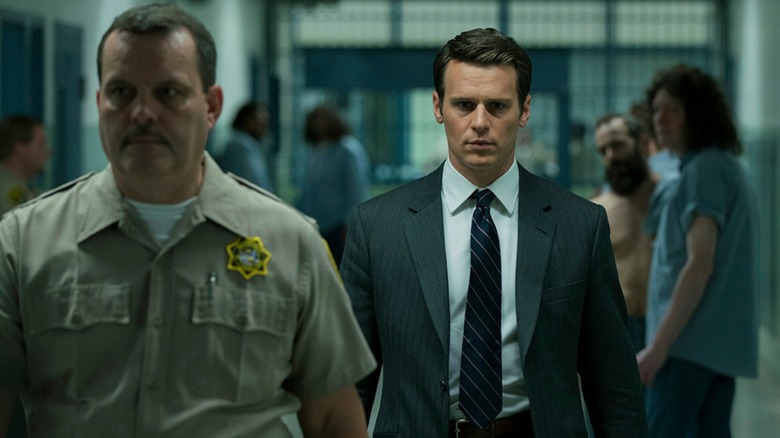 Holden walking through a prison on Mindhunter