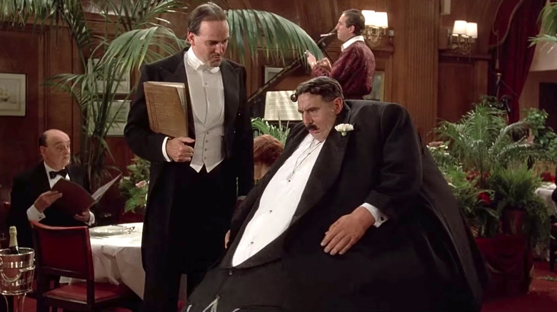 The Maitre'D greets Mr. Creosote