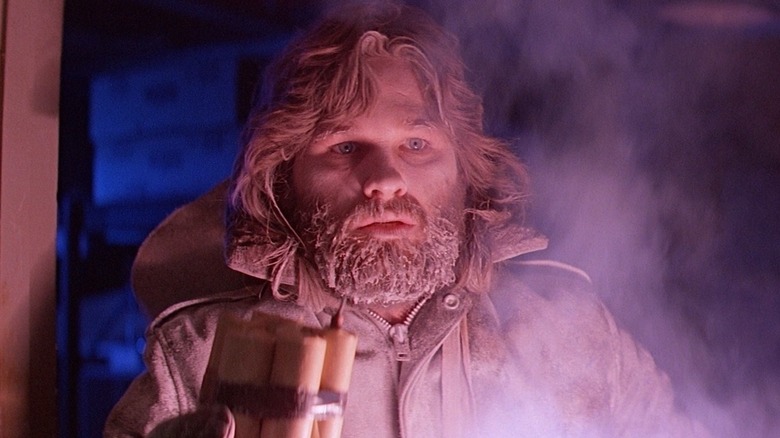 R. J. MacReady holding a bundle of dynamite in "The Thing"
