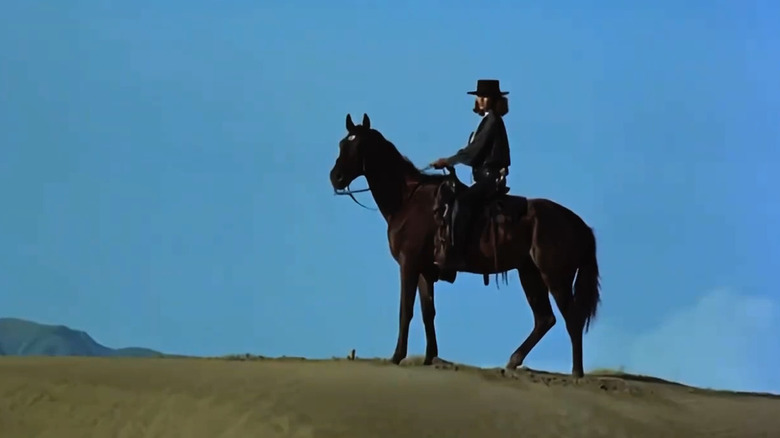 El Topo riding a horse through the desert