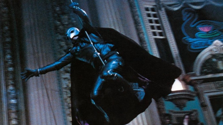 The Phantom swinging on rope through theater