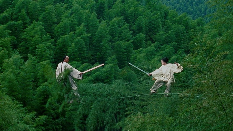 Mu Bai and Jen draw swords standing on bamboo in the forest in "Crouching Tiger, Hidden Dragon" (2000)