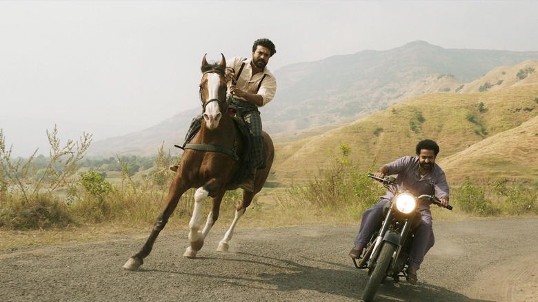 Ram on a horse races Bheem on a motorcycle in "RRR"