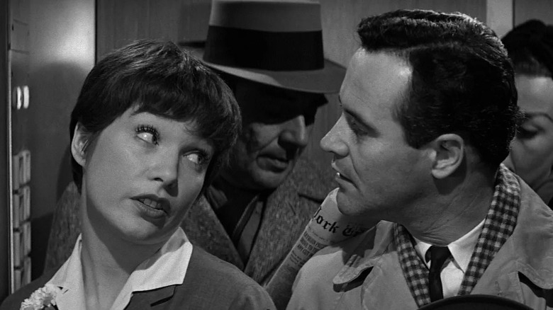 Fran and Bud make eye contact in an elevator in "The Apartment" (1960)