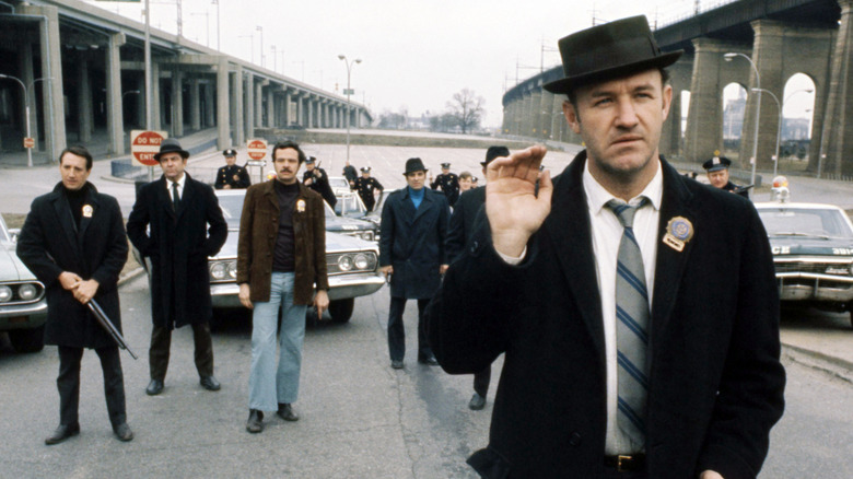 Popeye Doyle waves to a criminal in "The French Connection" (1971)