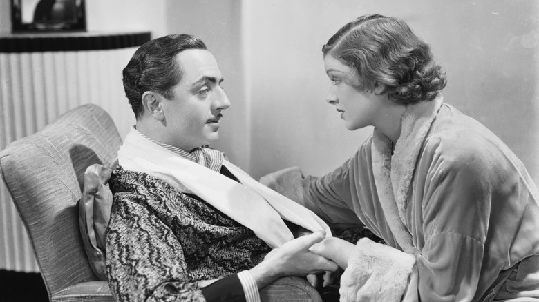 Nick and Nora Charles hold hands in "The Thin Man" (1934)