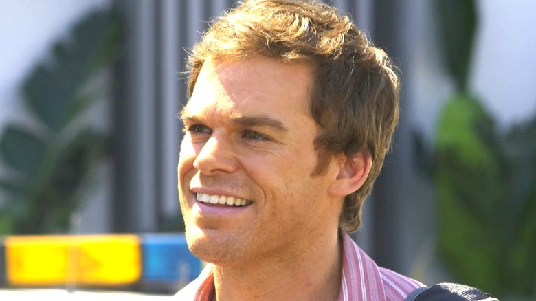 Dexter smiling, outside, wearing a striped shirt, on Dexter