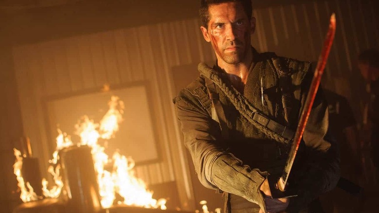 Casey wielding a katana in a burning room in "Ninja: Shadow of a Tear"