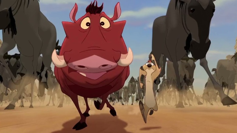 Timon and Pumbaa running in front of a stampede in "The Lion King 1 ½ "