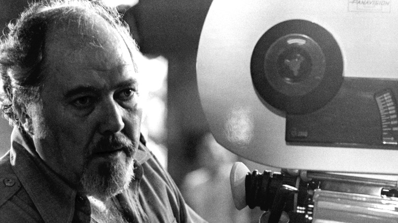 Robert Altman sits behind a camera