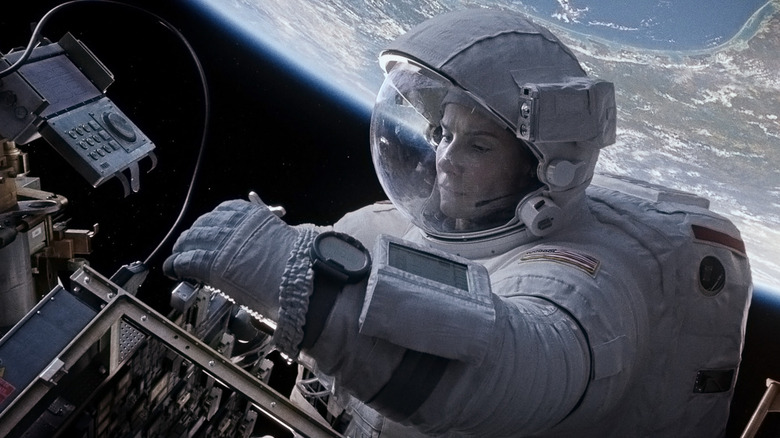 Ryan Stone fixing a satellite in "Gravity" (2013)