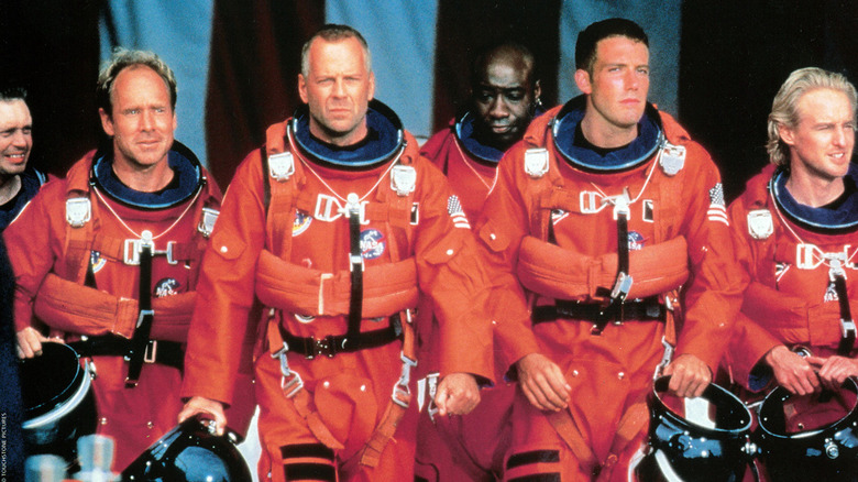 A band of oil drilling astronauts in orange prepare for space launch in 'Armageddon' (1998)