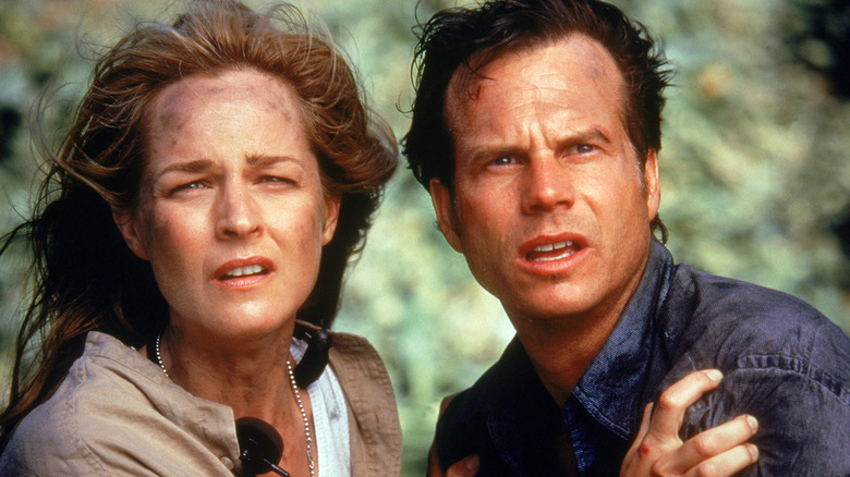 Jo and Bill Harding squinting at an approaching tornado in 'Twister' (1996)