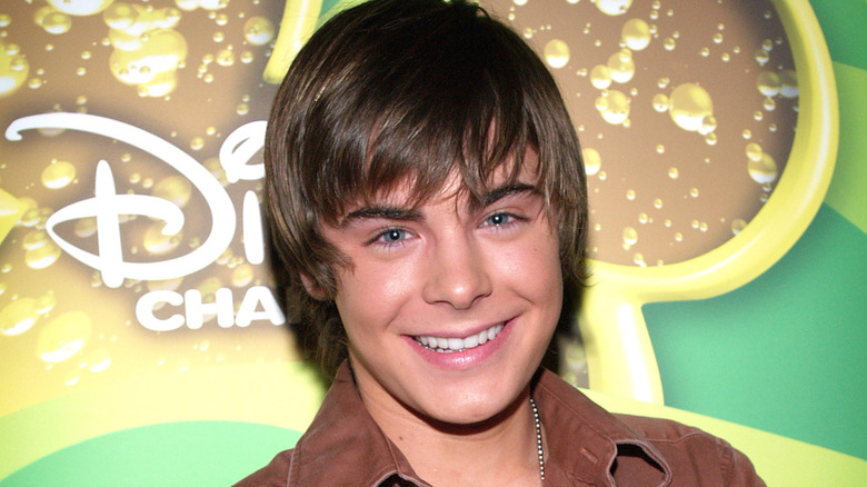 Zac Efron in front of Disney Channel sign