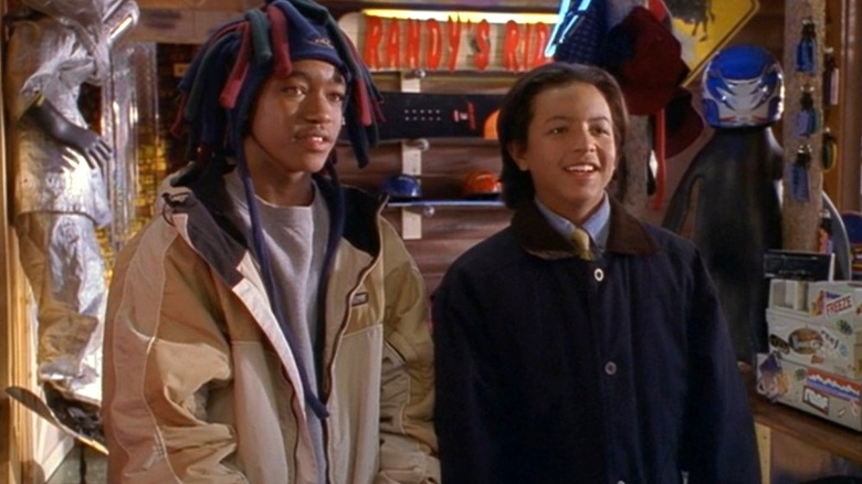 Sam Sterling stands next to Kapahaala in a snowboard shop in Johnny Tsunami