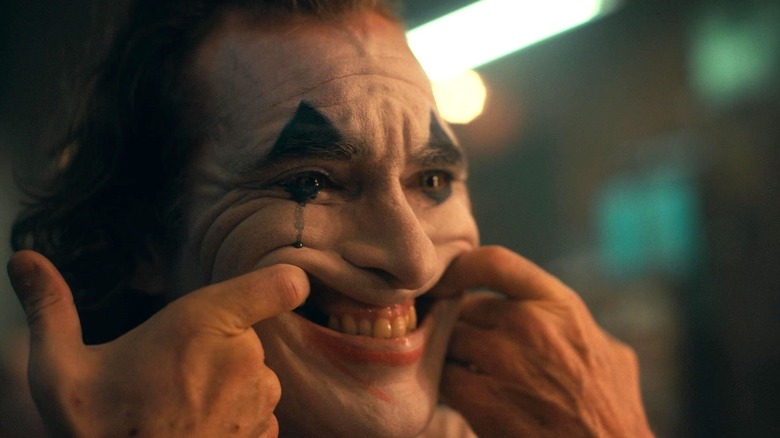 Joaquin Phoenix's Arthur Fleck pulling a smile in Joker