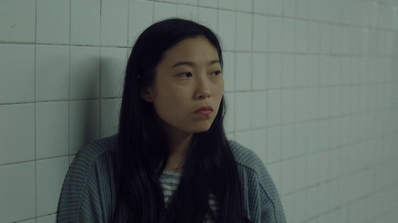 Billi Wang leaning on wall