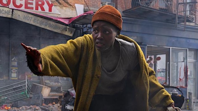 Sam creeps through wreckage in "A Quiet Place: Day One" (2024)
