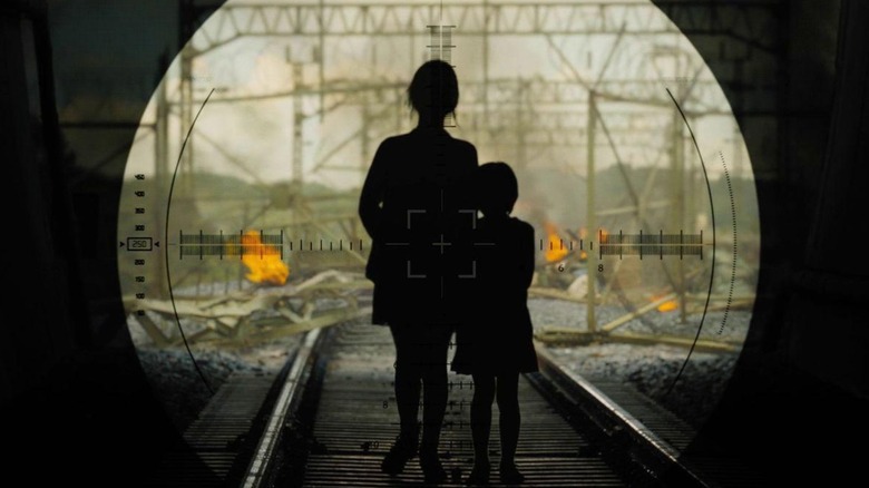 Soo-An and Sung-Gyeong stand silhouetted in a train tunnel in "Train to Busan" (2016)