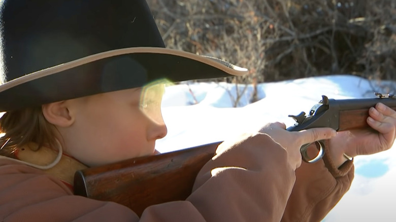 Kidd shooting a rifle