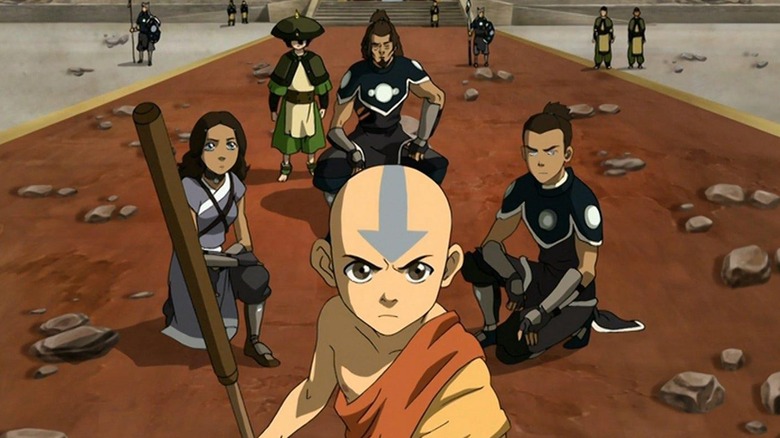 Aang, Katara, Sokka, and Toph forming a plan on the battlefield in Avatar: The Last Airbender season 3 (2007)