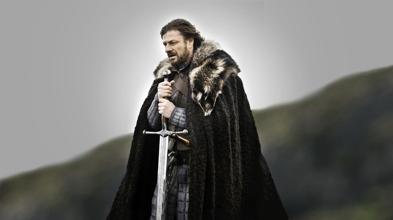 Ned Stark holding Ice to his chest in the first episode of Game of Thrones (2011)