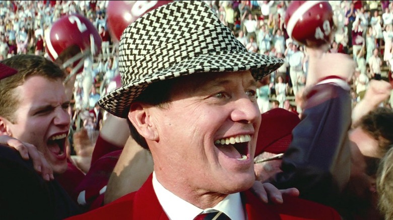 Bear Bryant smiling, wearing fedora