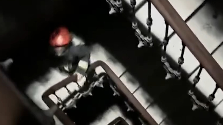 Infected apartment tenants climb a staircase in "[REC]" (2007)