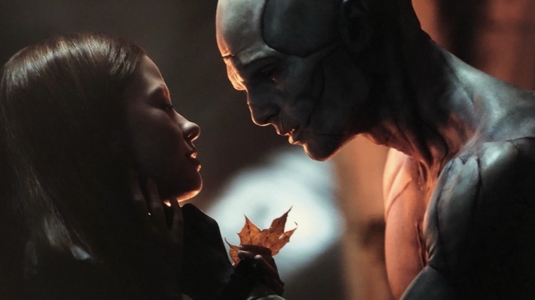 The Creature gives a leaf to Elizabeth in Frankenstein (2025)