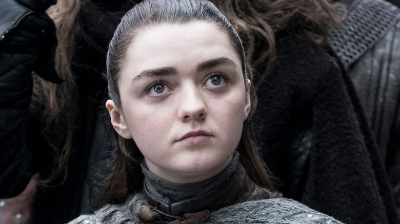 Arya standing in a crowd in Winterfell