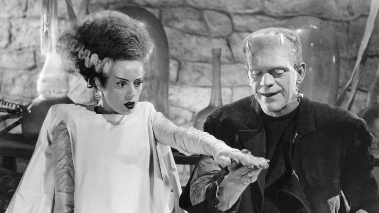 The Monster holds the Bride's hand in "Bride of Frankenstein" (1935)