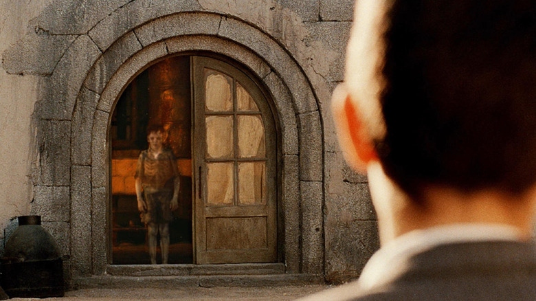 A ghost stares out from a window in "The Devil's Backbone" (2001)