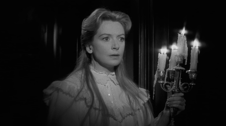 Miss Giddens holds a candelabra in "The Innocents" (1961)