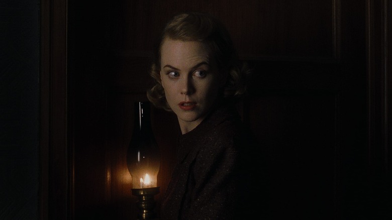 Grace Stewart walks through a darkened house in "The Others" (2001)