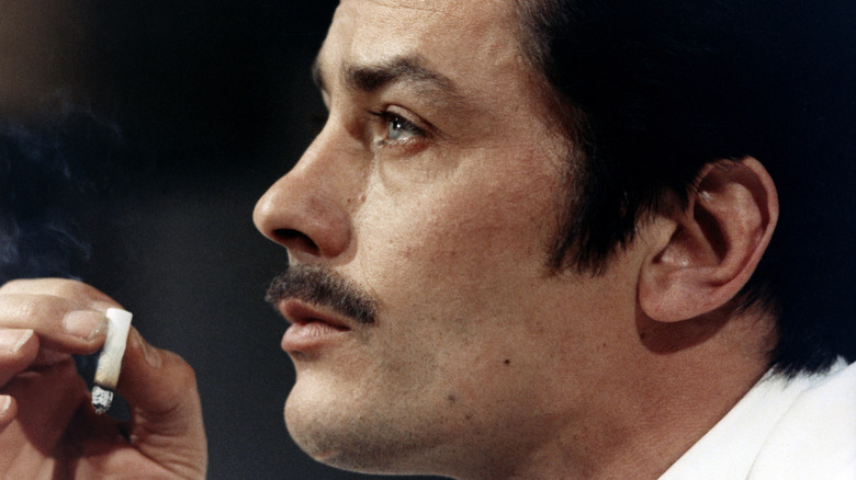 Jansen in Le Cercle Rouge holding a cigarette