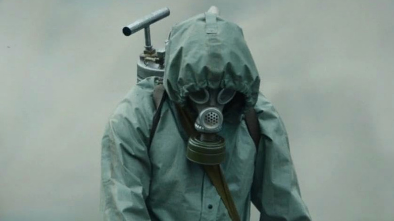 A man in a gas mask and protective gear in Chernobyl