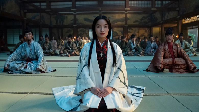 Lady Mariko sitting in front of two lords in Shogun