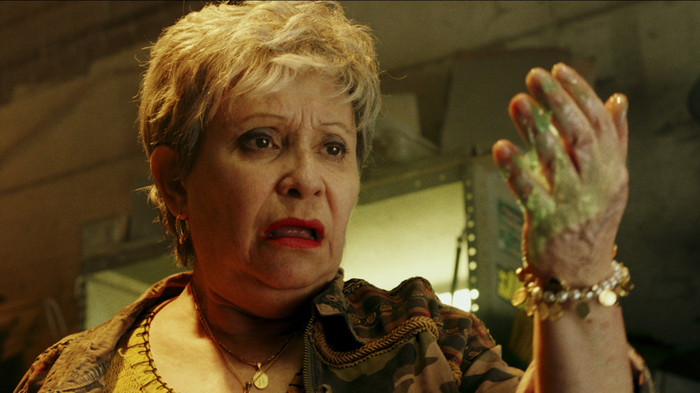 Woman looking at slime on her hand