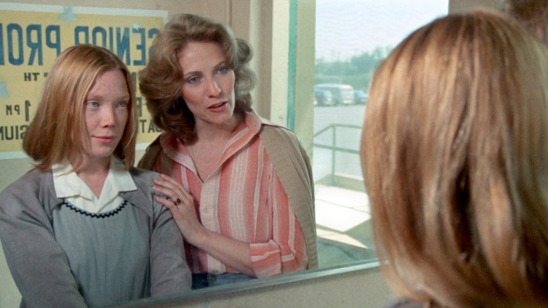 Carrie and Mrs. Collins in a mirror