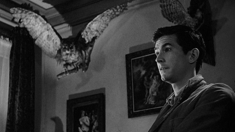 Norman Bates next to taxidermied owl