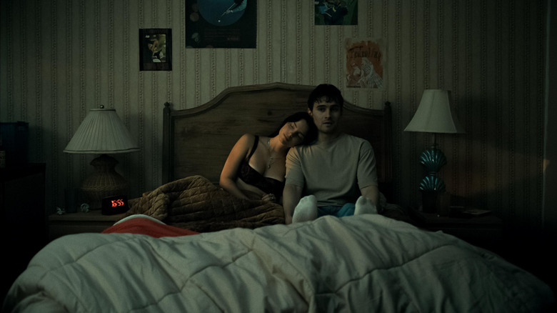 Nikki cozying up to Bear in bed in "Obsession"