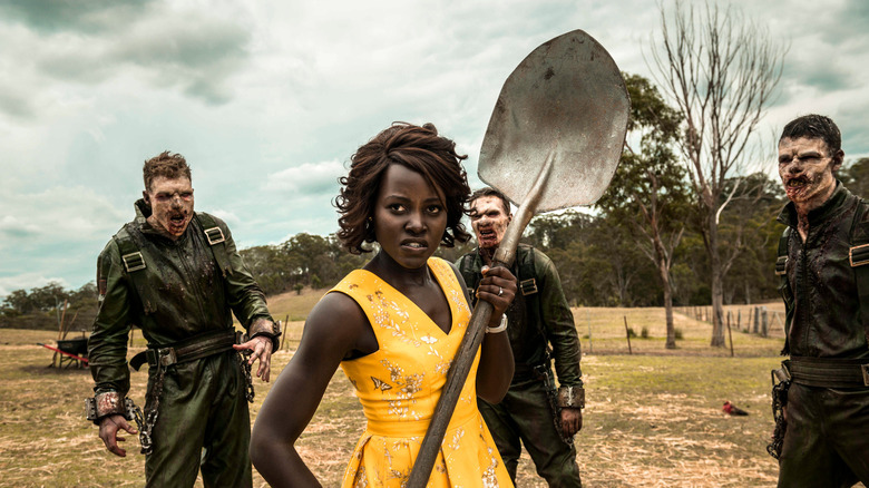 Miss Caroline wields a shovel as zombies approach her in "Little Monsters"