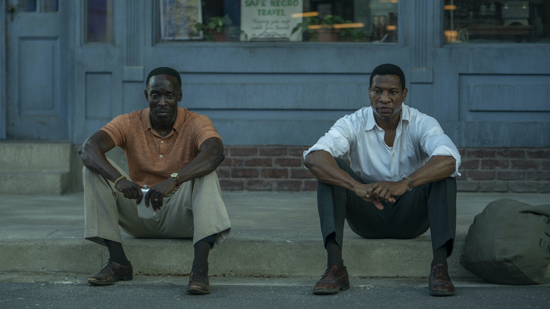 Montrose and Atticus Freeman sitting on a curb on "Lovecraft Country" (2020)