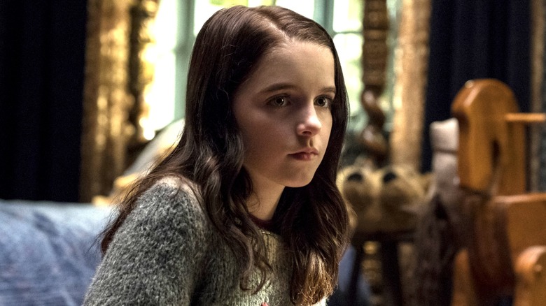 Young Theo sitting on a couch in 