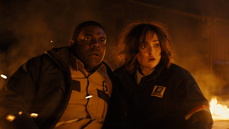 Finn and Cecily with flames behind them in "Werewolves Within"