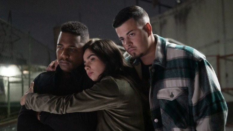 Nando, Rita, and Doni embracing with stern expressions on Sintonia