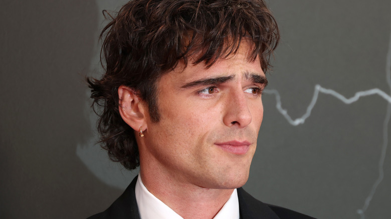 Jacob Elordi in a suit and wearing an earring