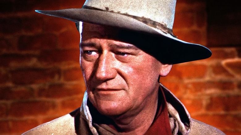 John Wayne with a brick background